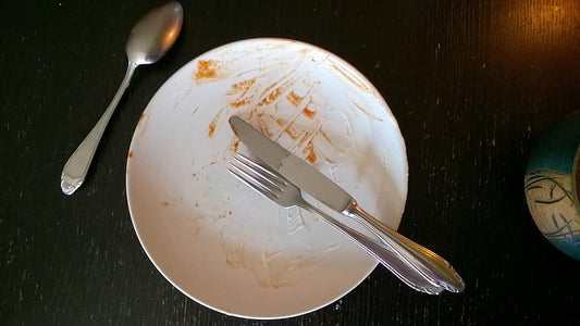 A plate with only crumbs left on it