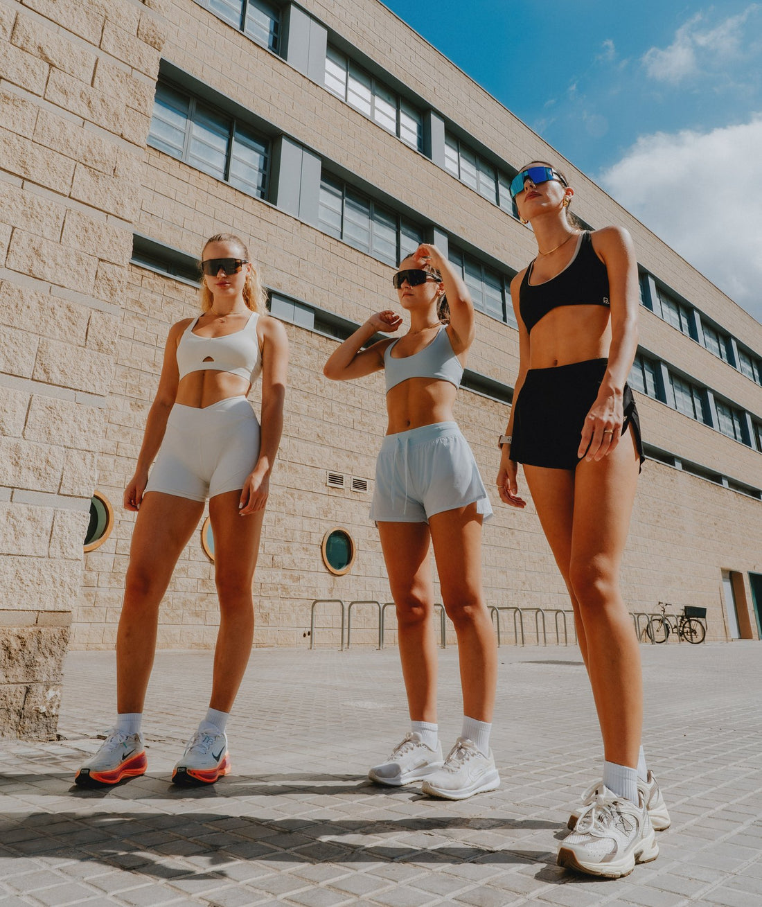 Three women in Runner's Athletics sets and sport sunglasses