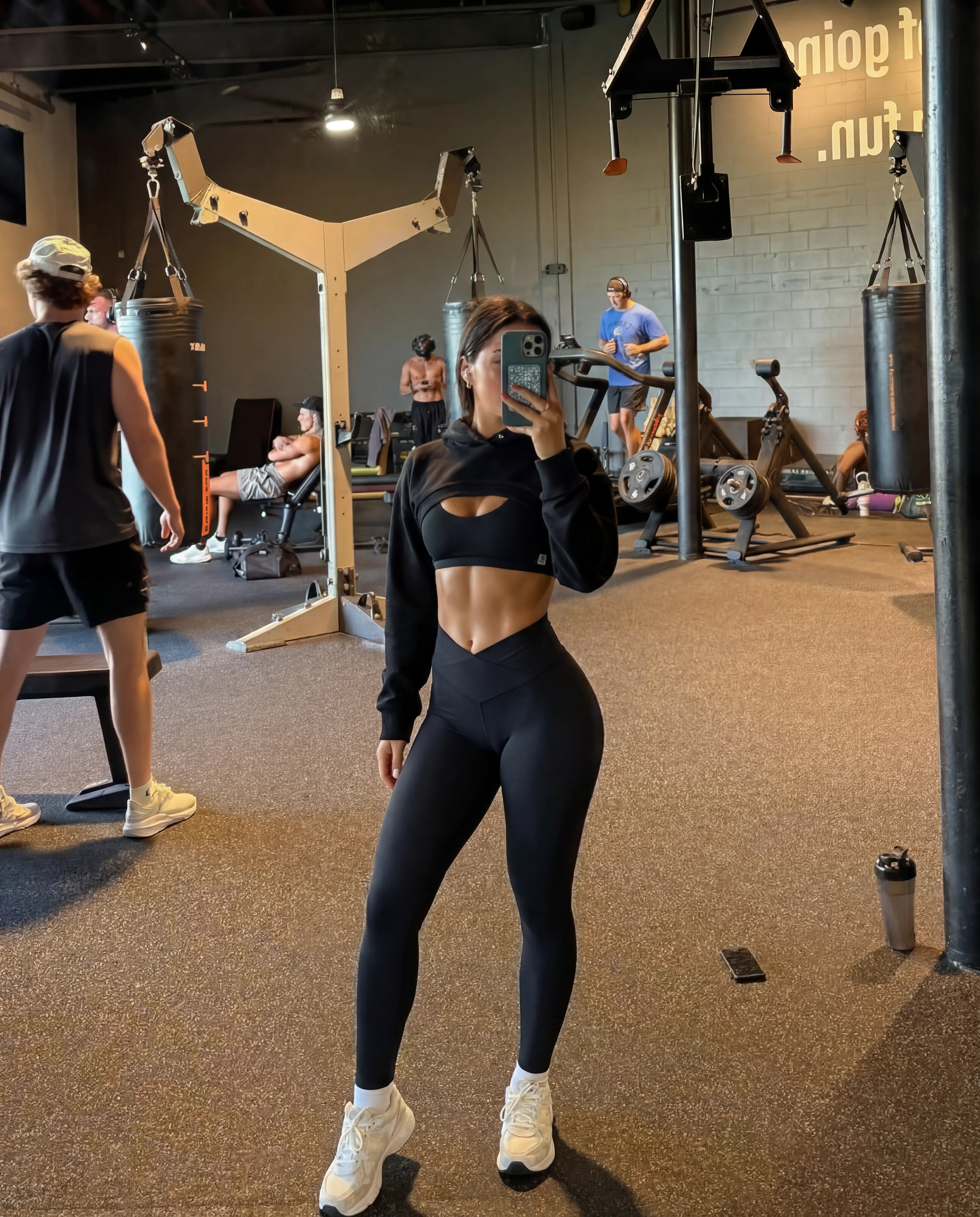 Black cropped hoodie and leggings gym mirror selfie full body view