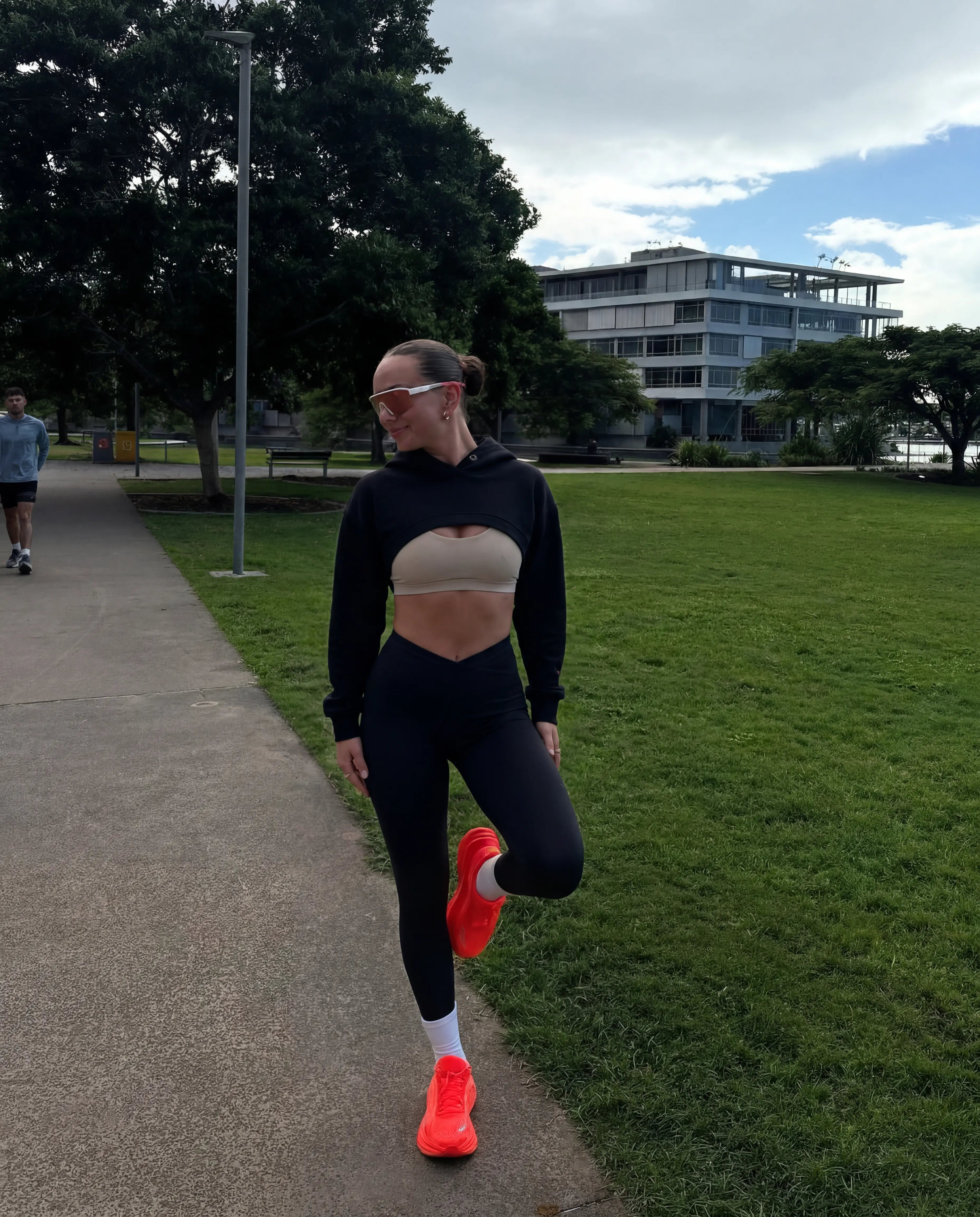 Black cropped hoodie and high waist leggings worn on outdoor park run