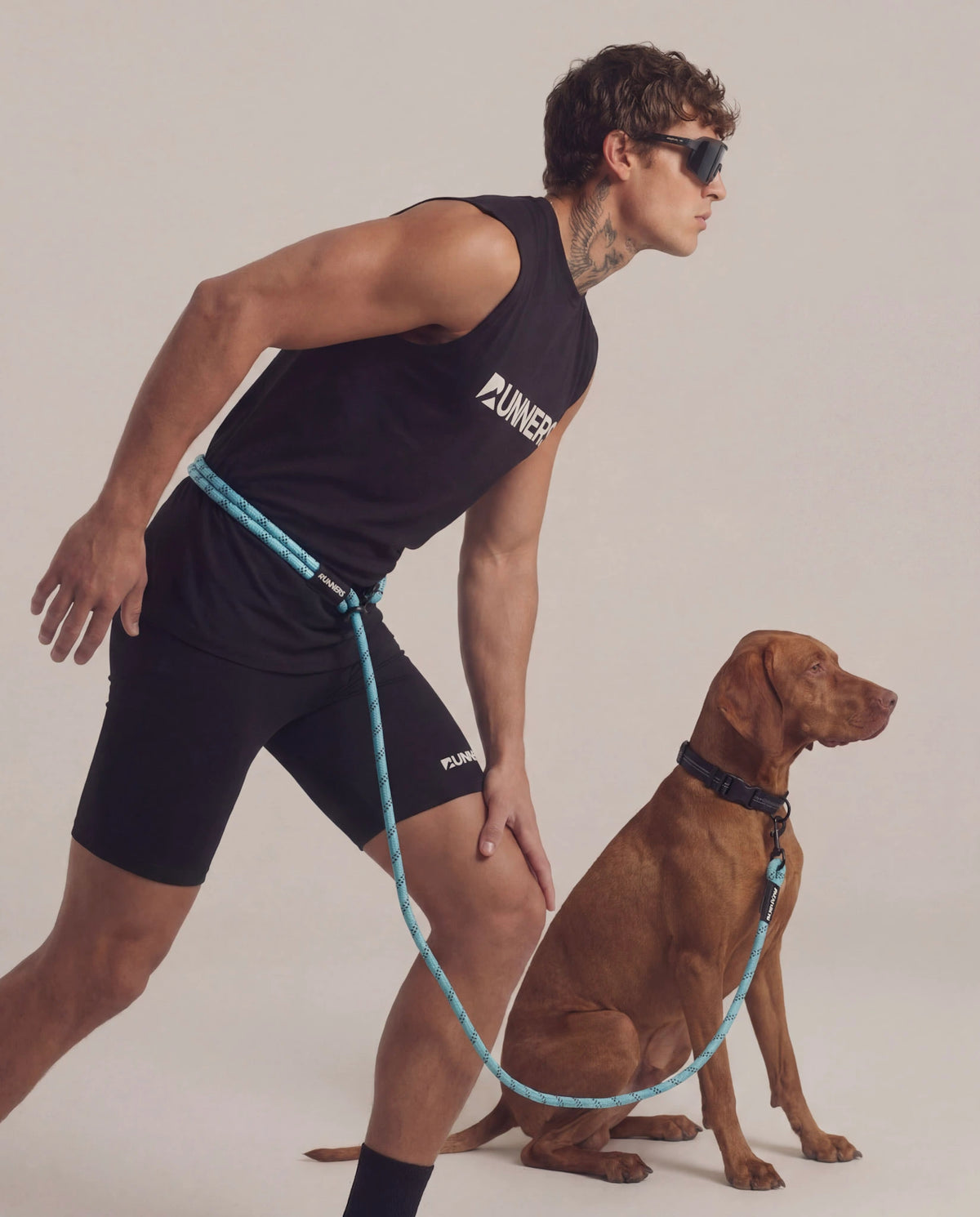 Aqua blue hands free dog leash worn around waist while running with dog