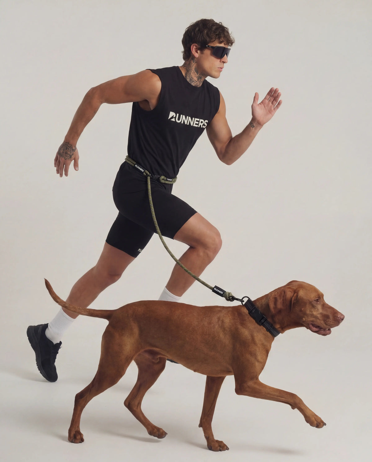 Olive hands free dog leash worn around waist while running with dog