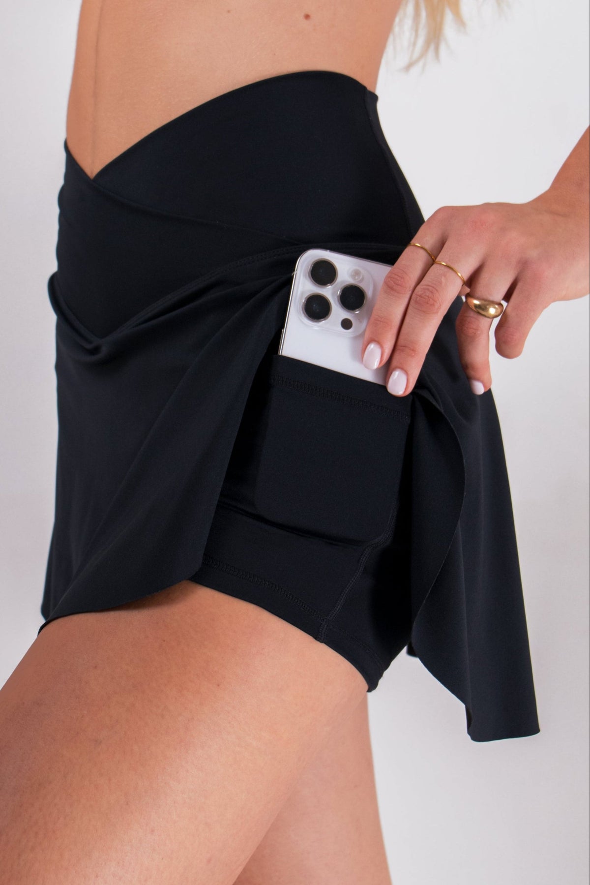 Runner's Athletics - Smartphone in pocket of black skort in LuxeForm athletic wear