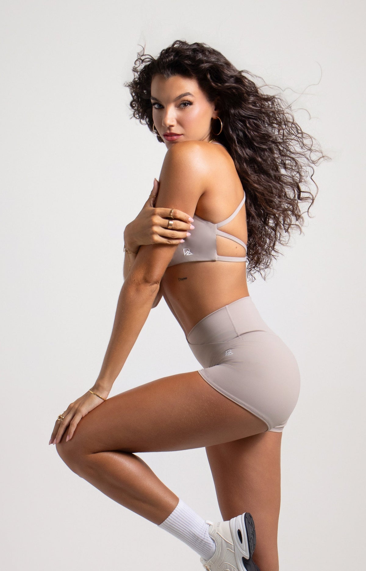 Light gray strappy sports bra with side cut-outs & matching shorts at Runner's Athletics