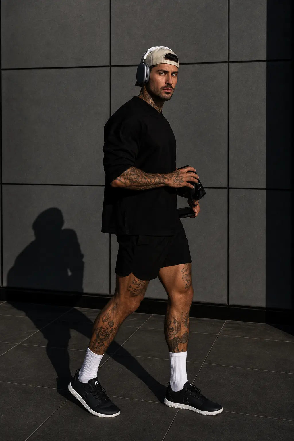 Black mens barefoot trainer minimalist shoe on model urban lifestyle editorial