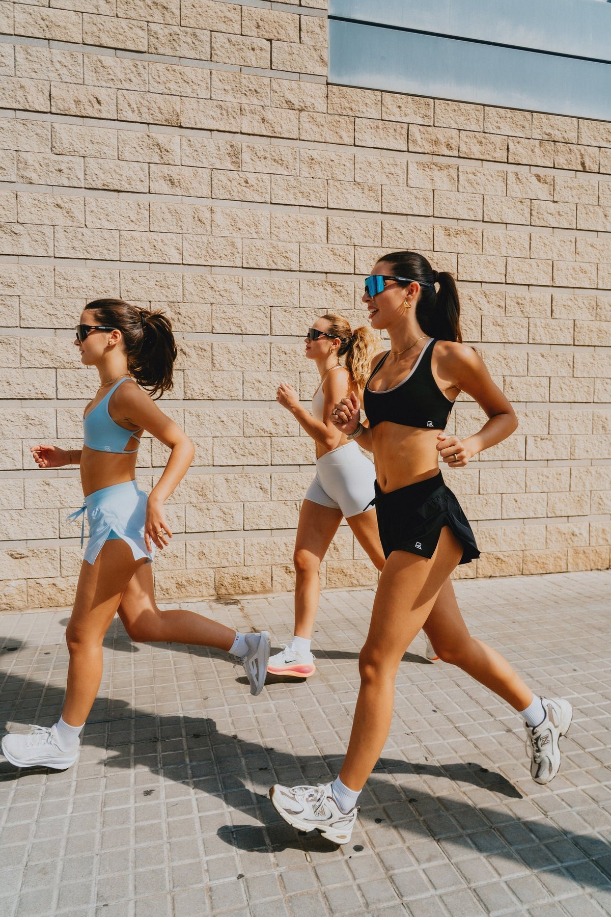 Three women running in Runner's Athletics sets in Barcelona