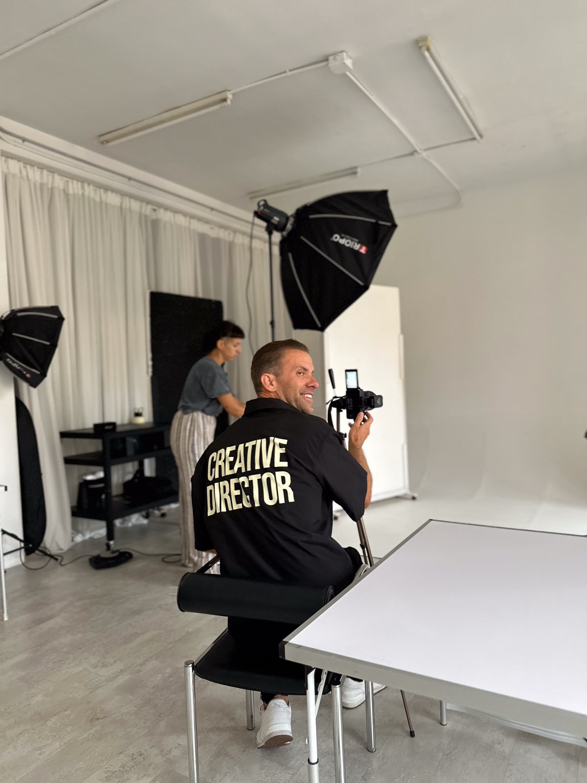 Joe, co-founder and creative director of Runner's Athletics, on set with a camera