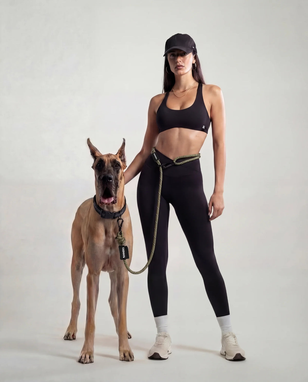 Woman jogging with dog wearing Runner's Athletics hands-free running leash system