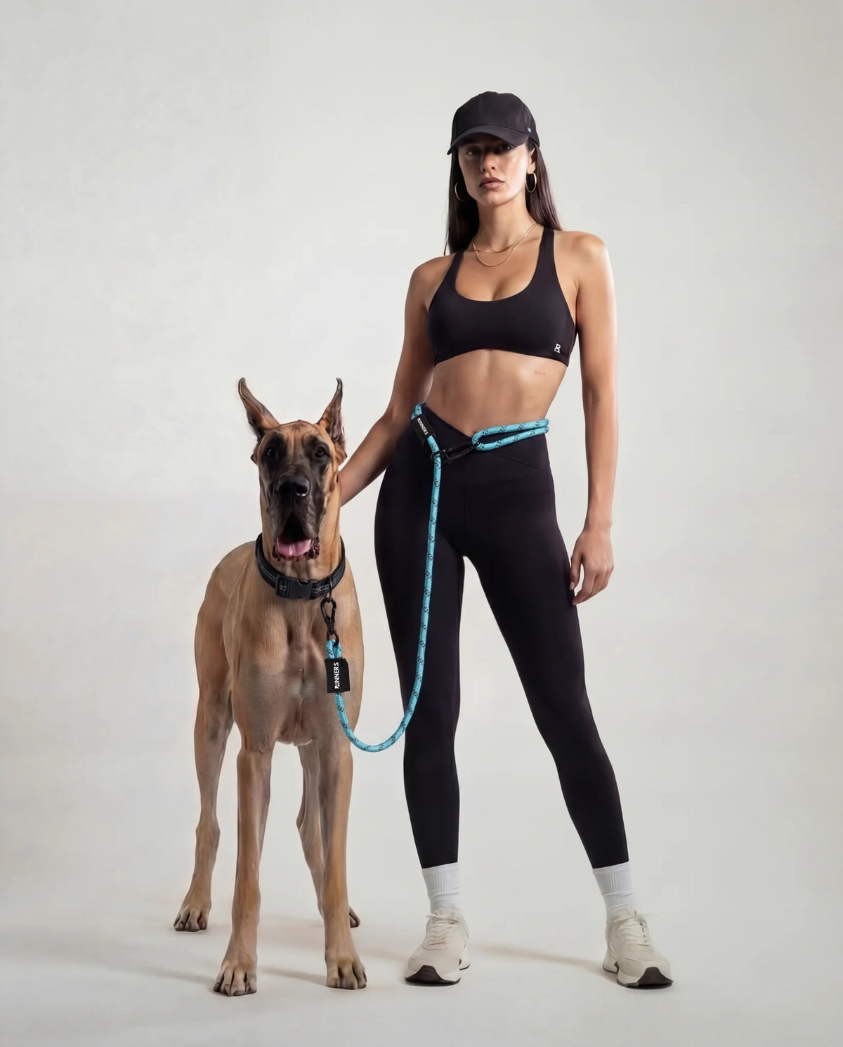 Woman jogging with dog wearing Runner's Athletics hands-free running leash system