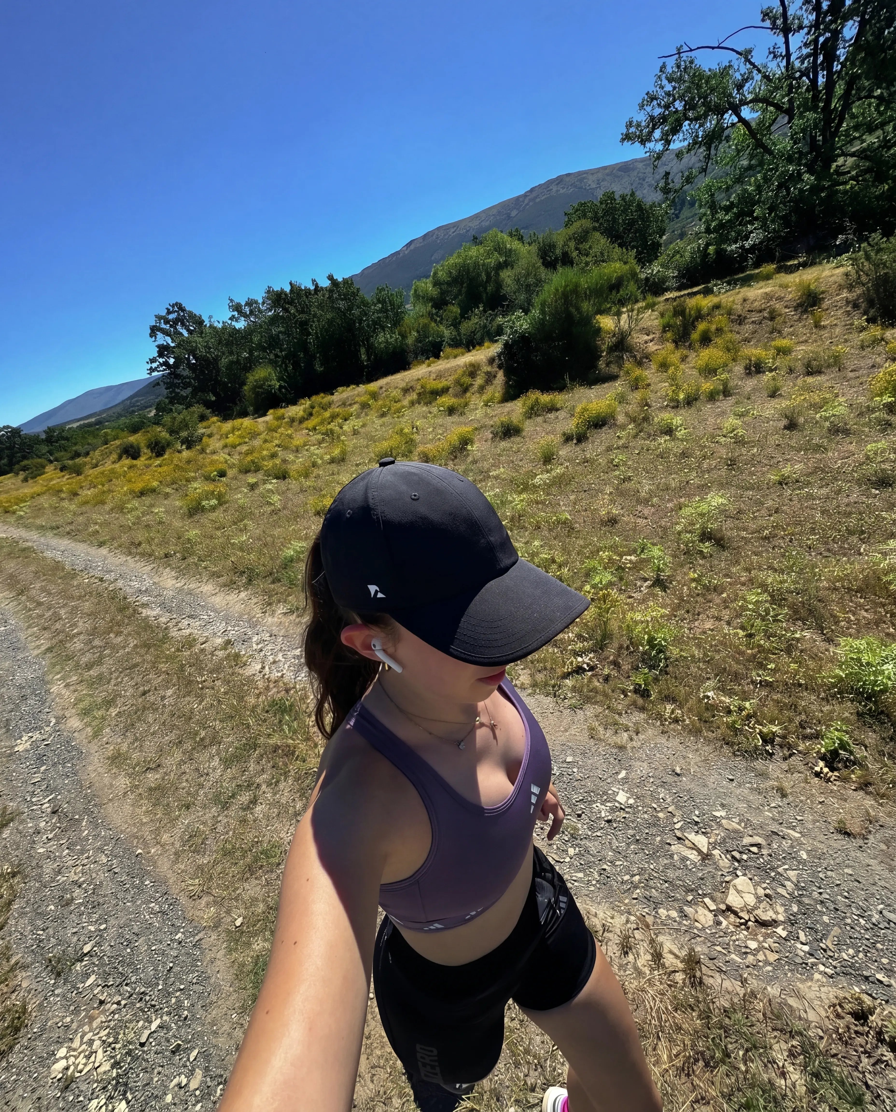 Black running hat on outdoor mountain trail run GoPro selfie