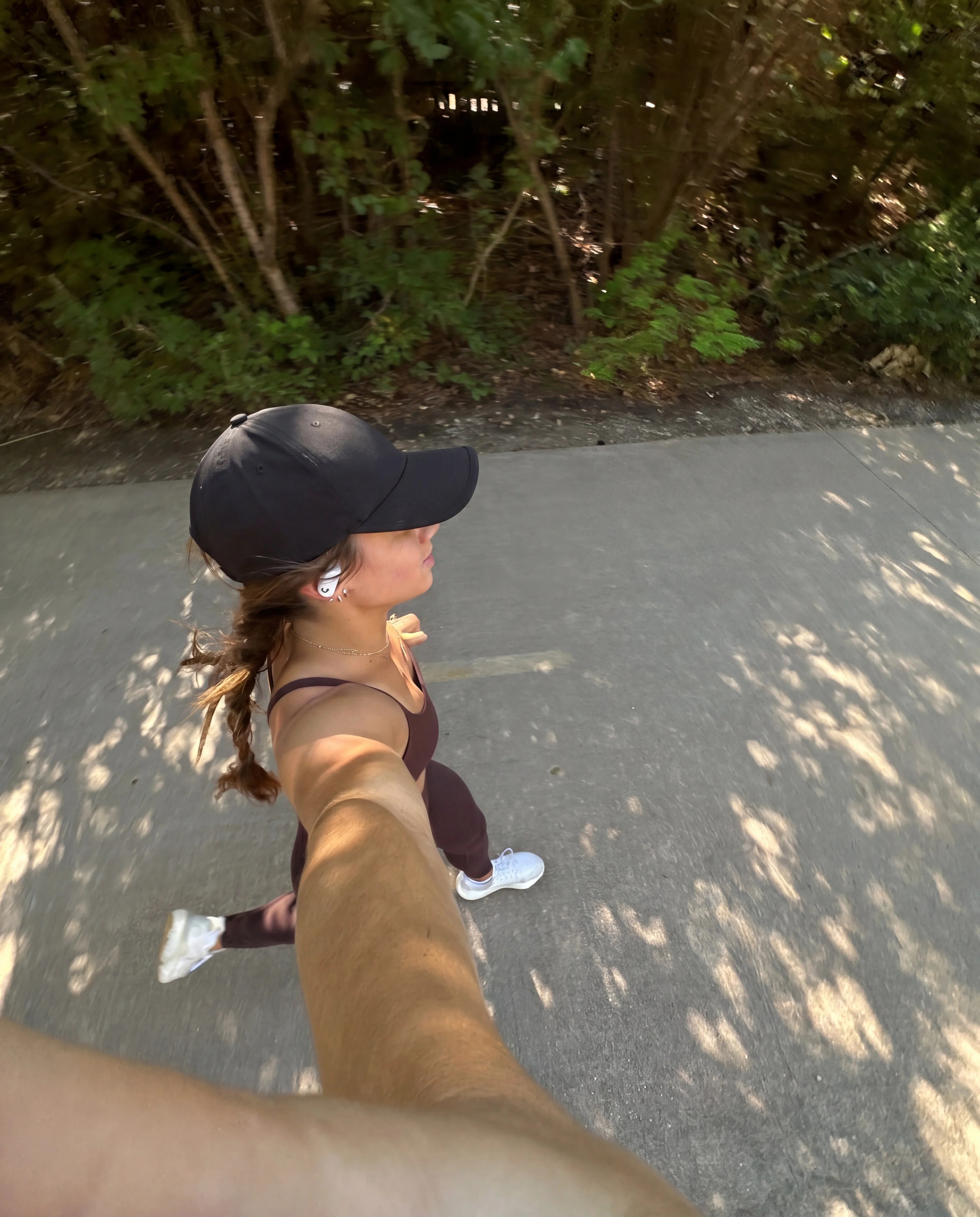 Black running hat worn on outdoor path run GoPro angle view
