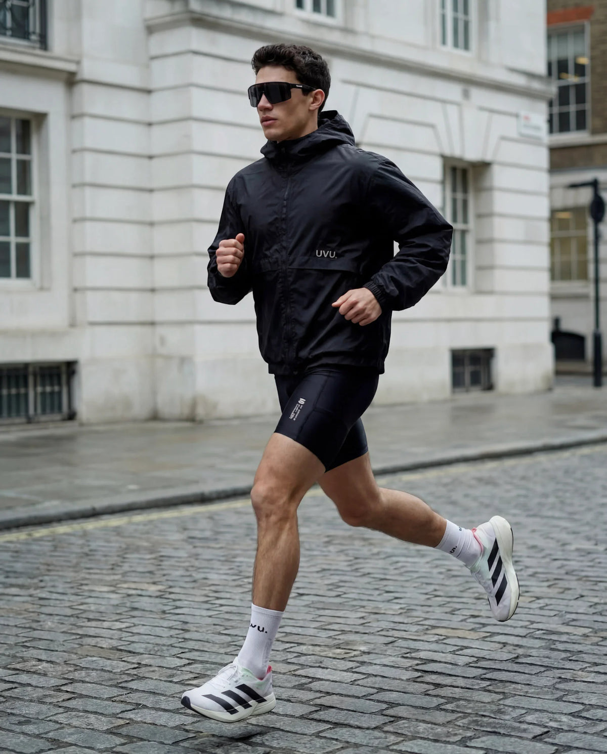 Man running wearing blackout running sunglasses
