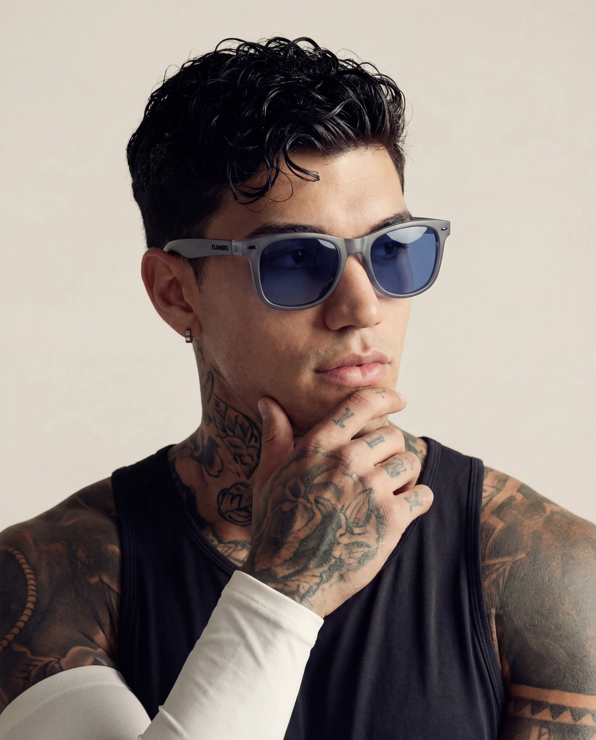 Frosted grey running sunglasses with blue lenses on tattooed male model
