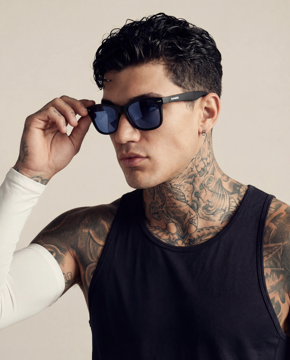 Matte black running sunglasses with blue lenses on tattooed male model