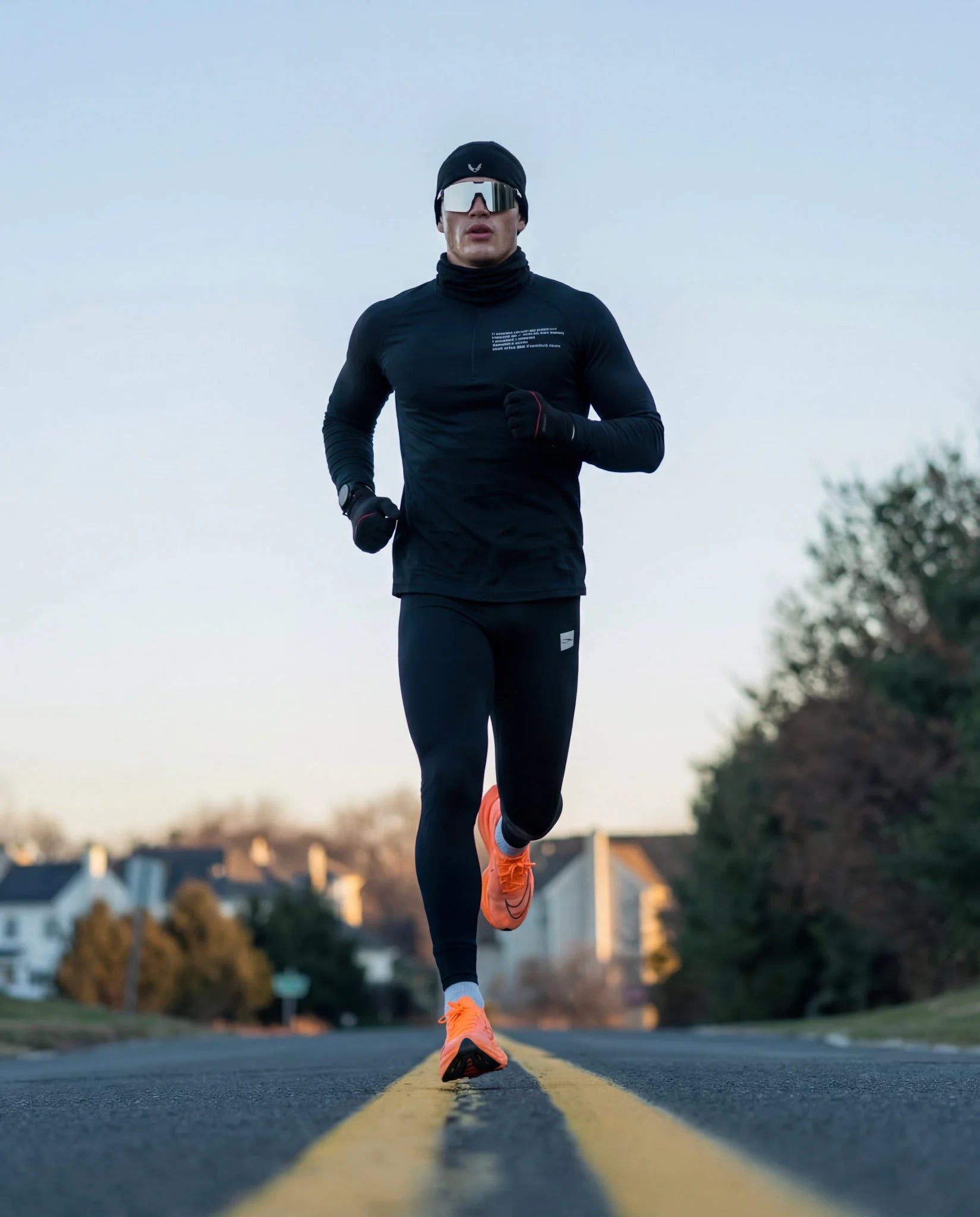 Man road running in winter gear wearing revo silver running sunglasses
