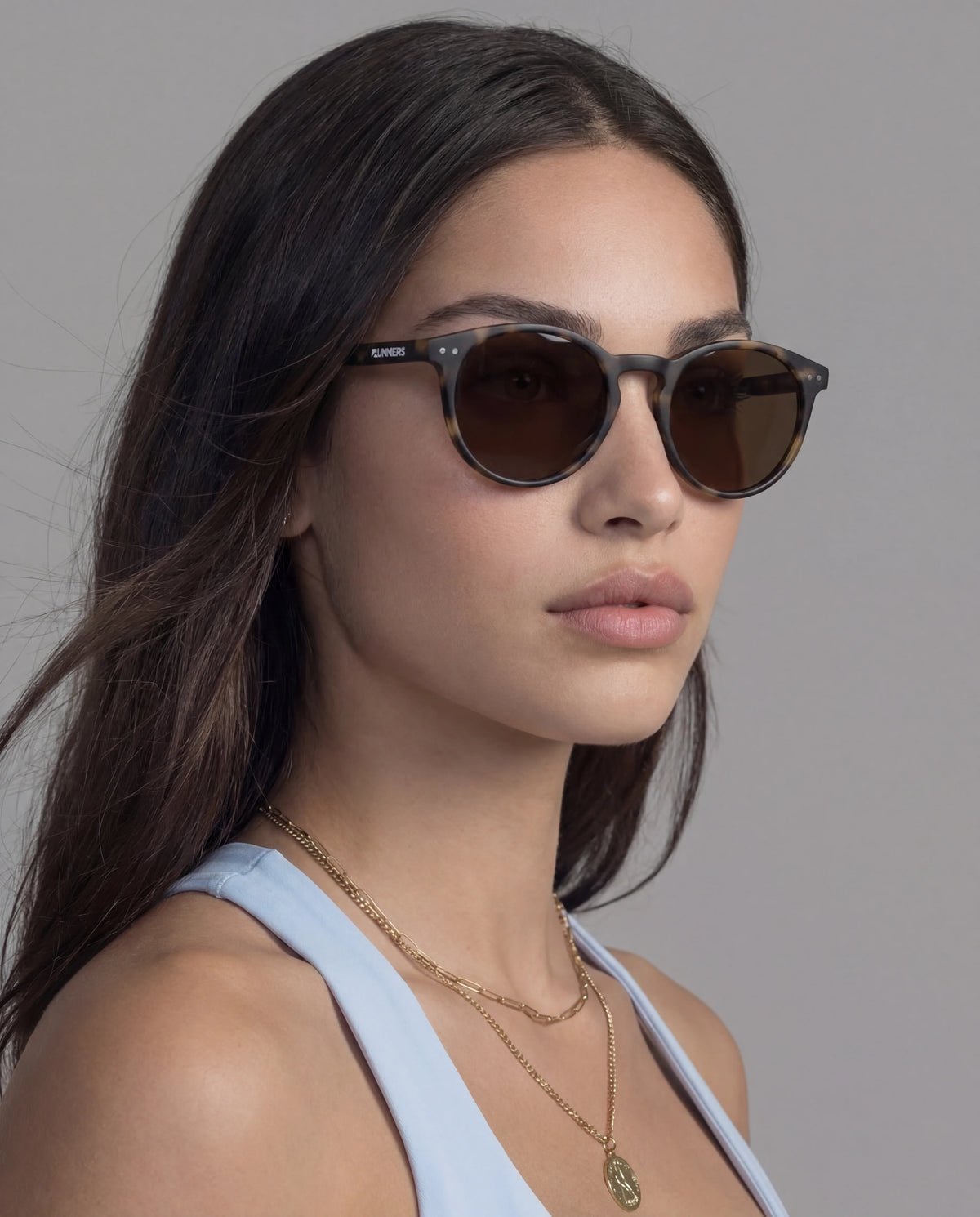 Tortoise round running sunglasses with brown lenses on woman 