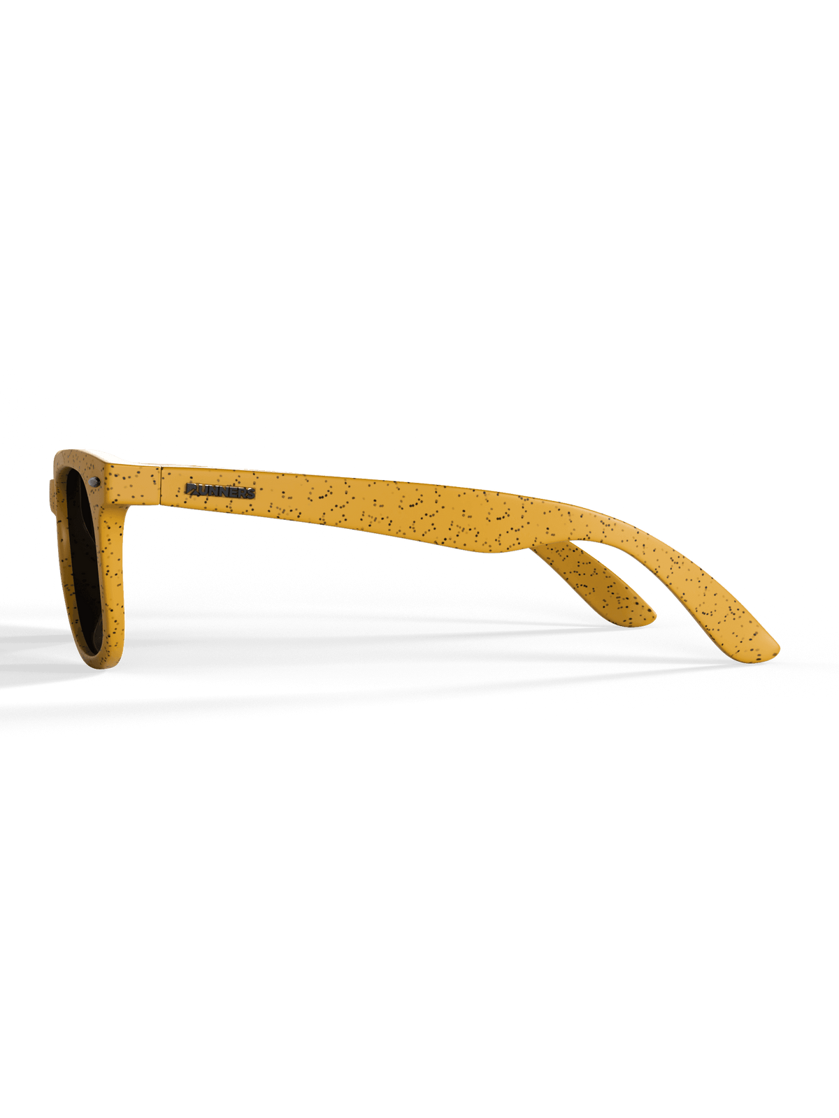 Angled shot of yellow sunglasses with black speckles.