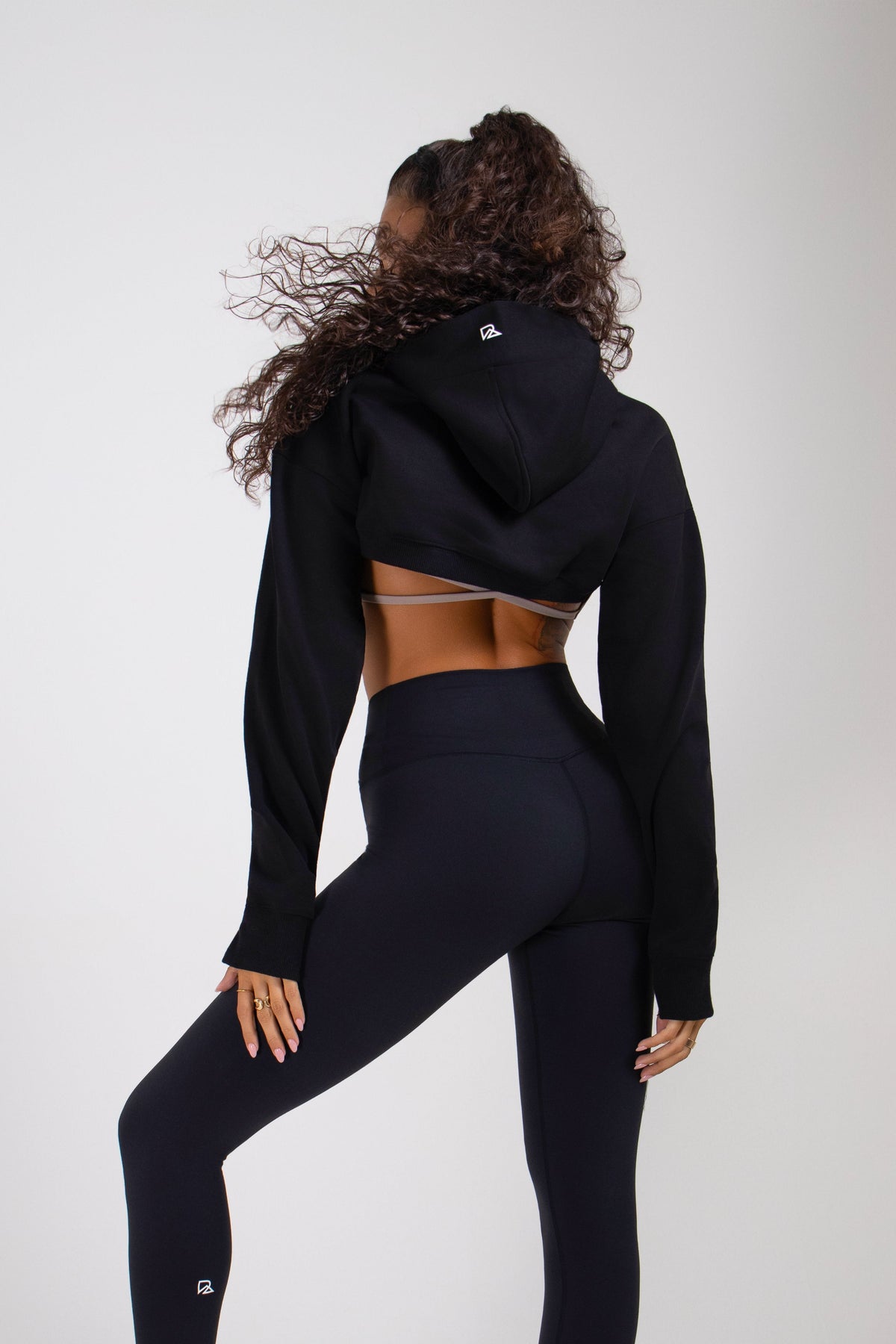 Back view of black hoodie with logo, high-waist leggings - Runner's Athletics