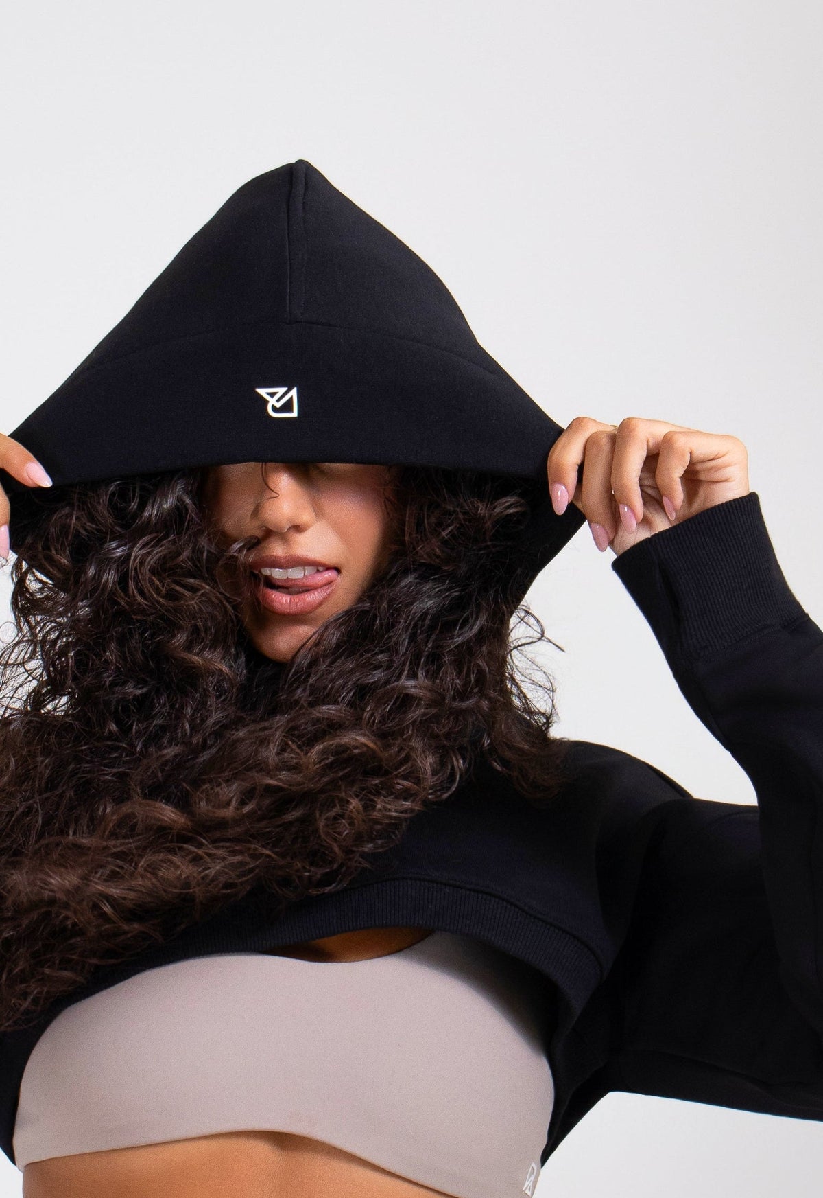 Black cropped hoodie with white logo, premium athletic apparel from Runner's Athletics