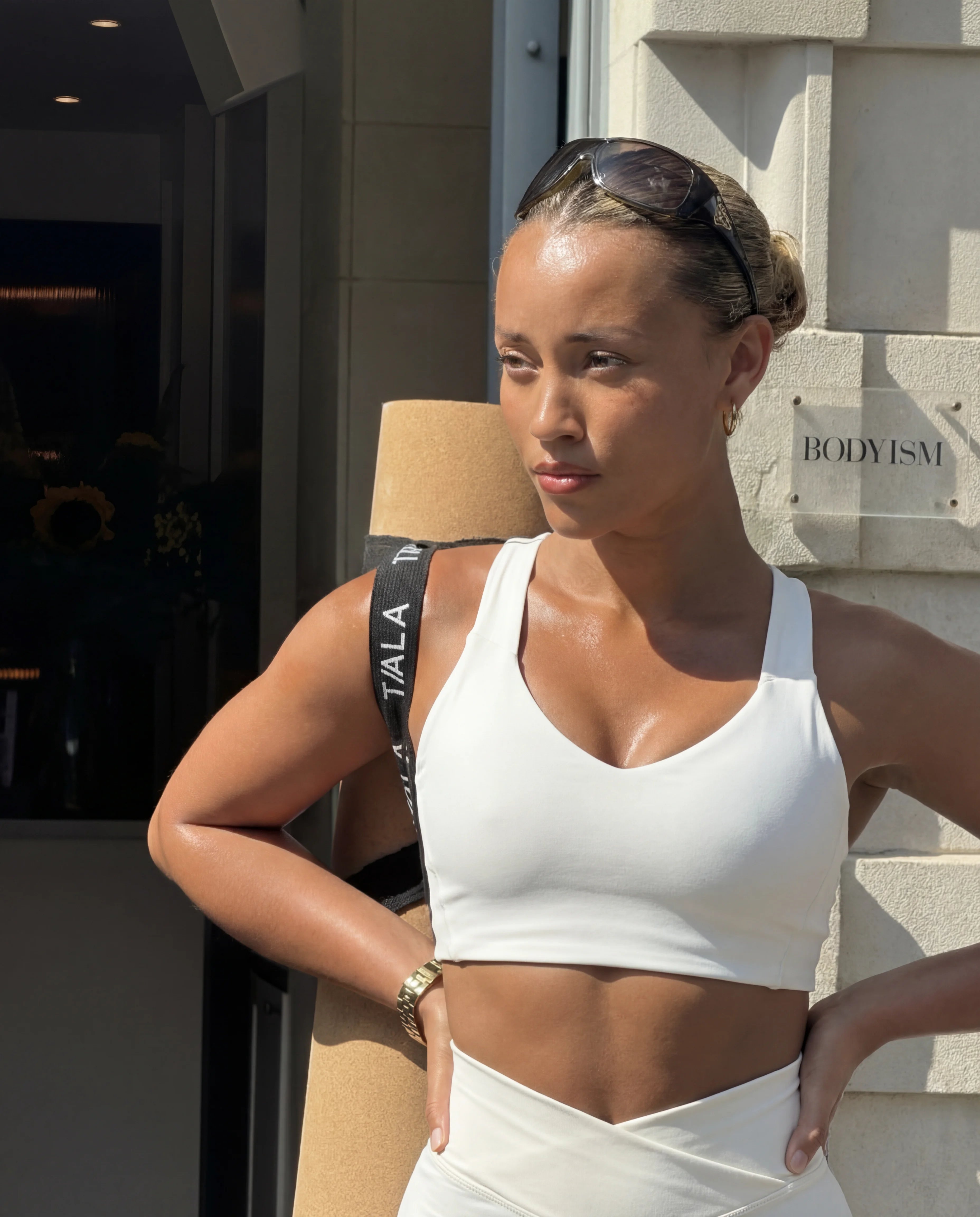 Beige workout set functional tank and sculpting shorts worn outside gym lifestyle