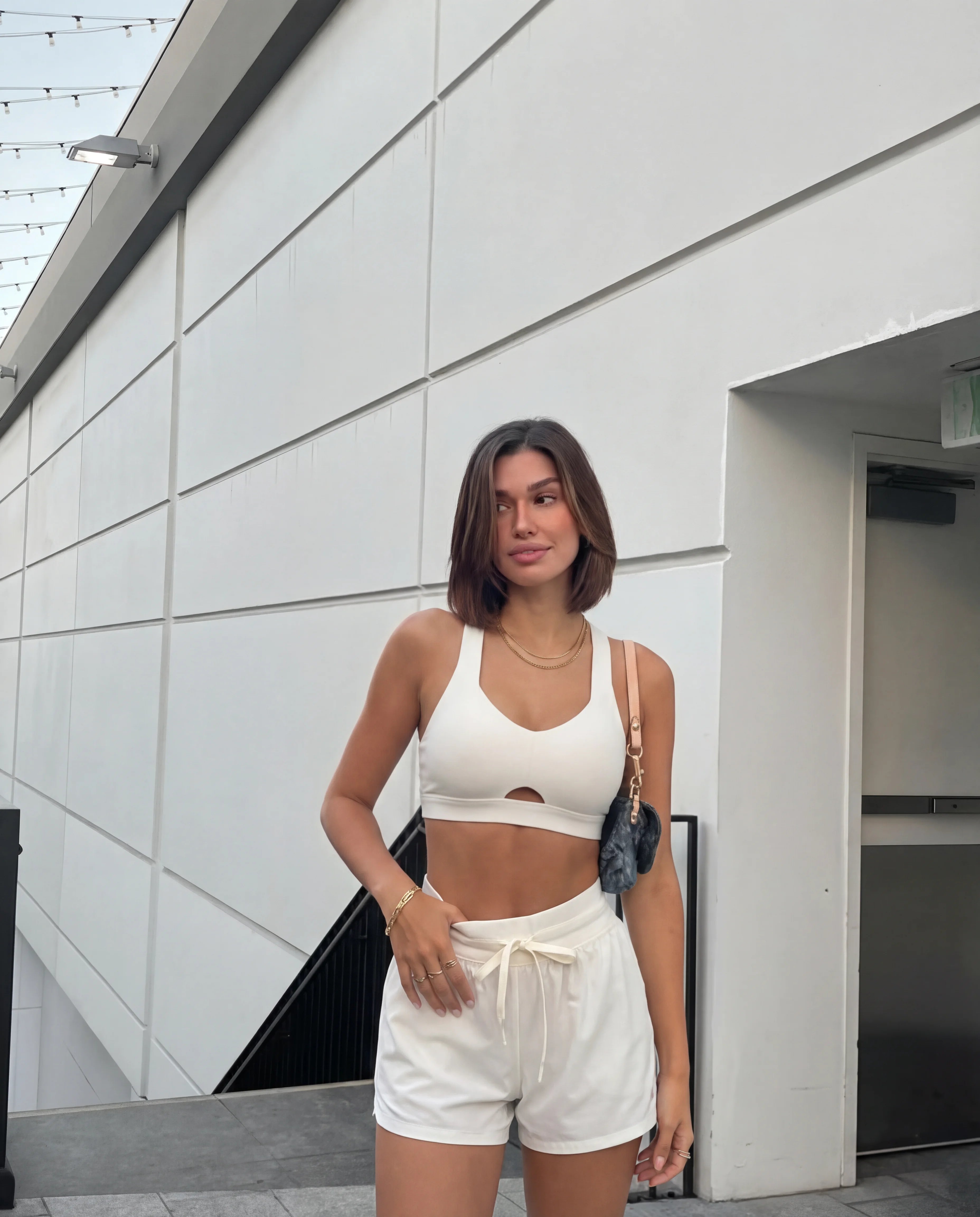 Beige workout set heart bra and flyaway shorts worn outdoors urban setting