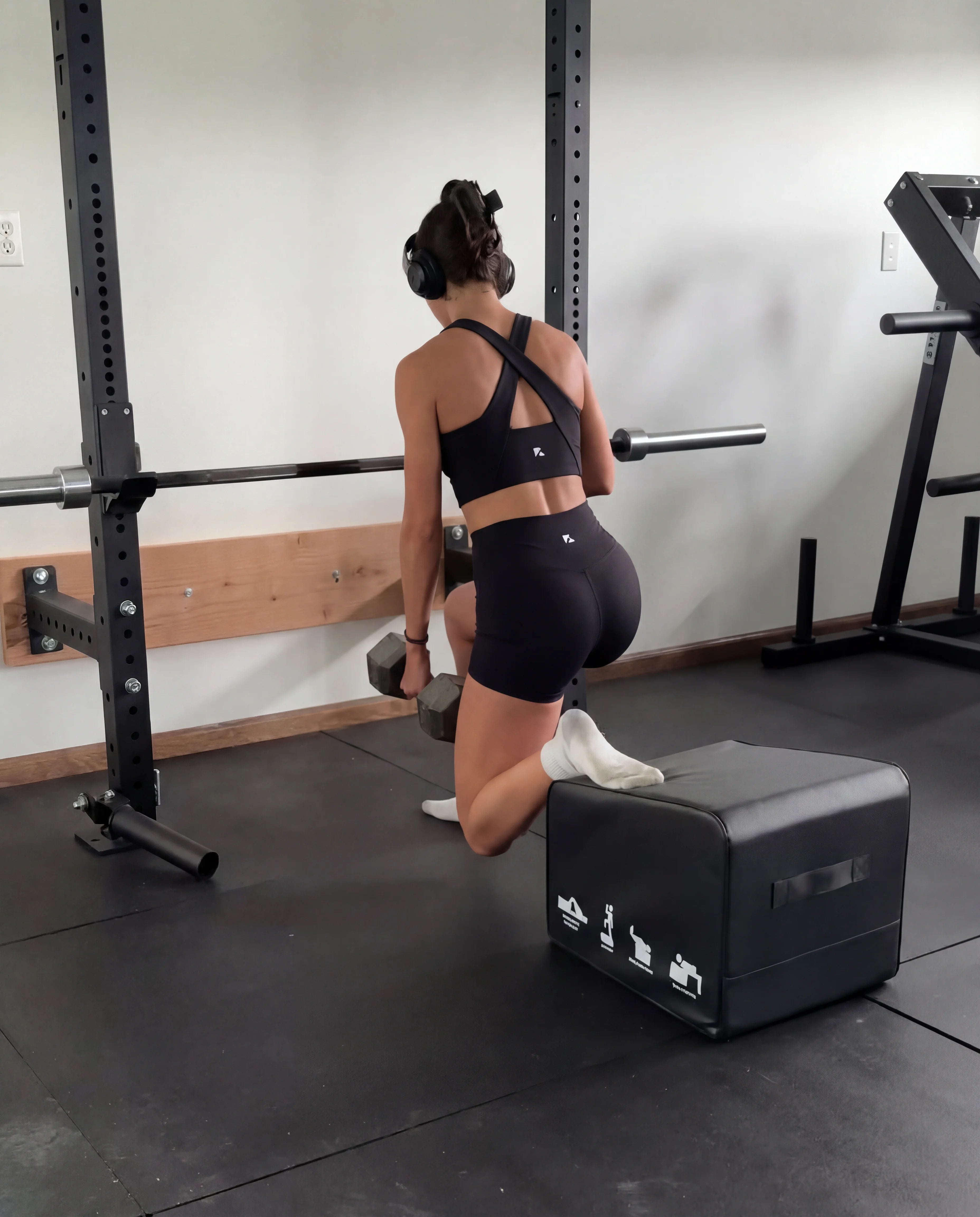 Black workout set functional tank and sculpting shorts back view doing lunges in gym