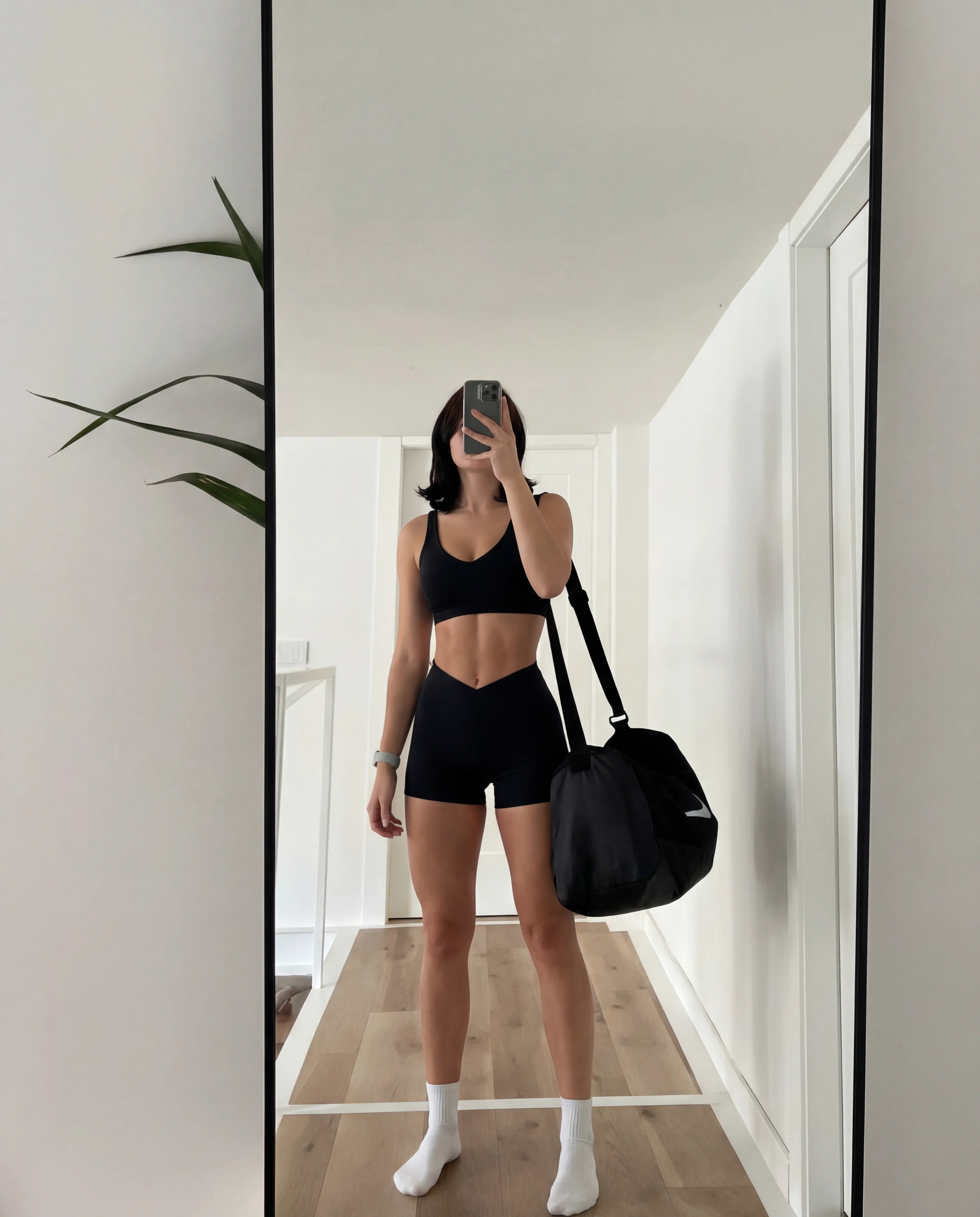 Black workout set functional tank and sculpting shorts home mirror selfie with gym bag