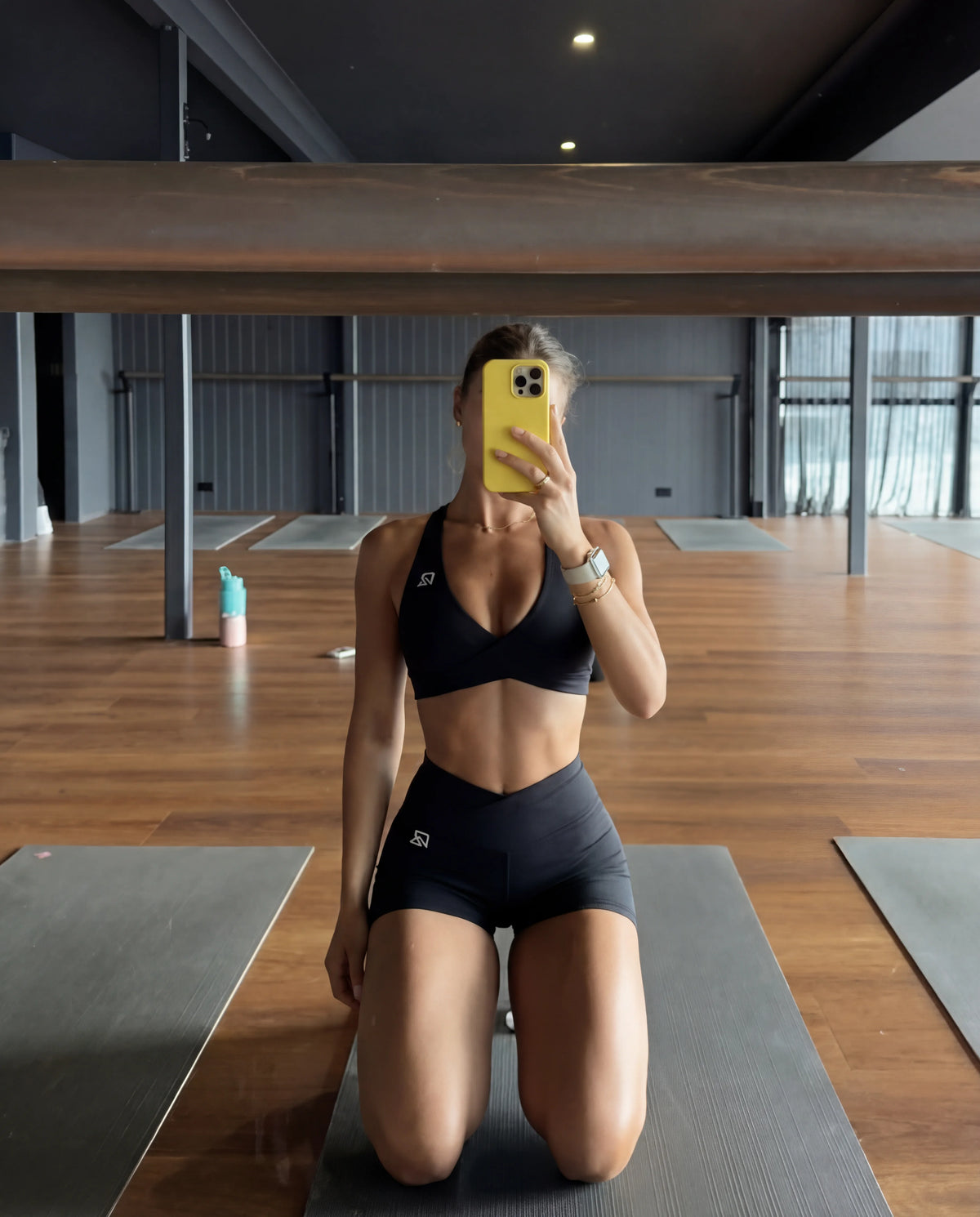 Black workout set halter bra and mini sculpting shorts yoga studio mirror selfie