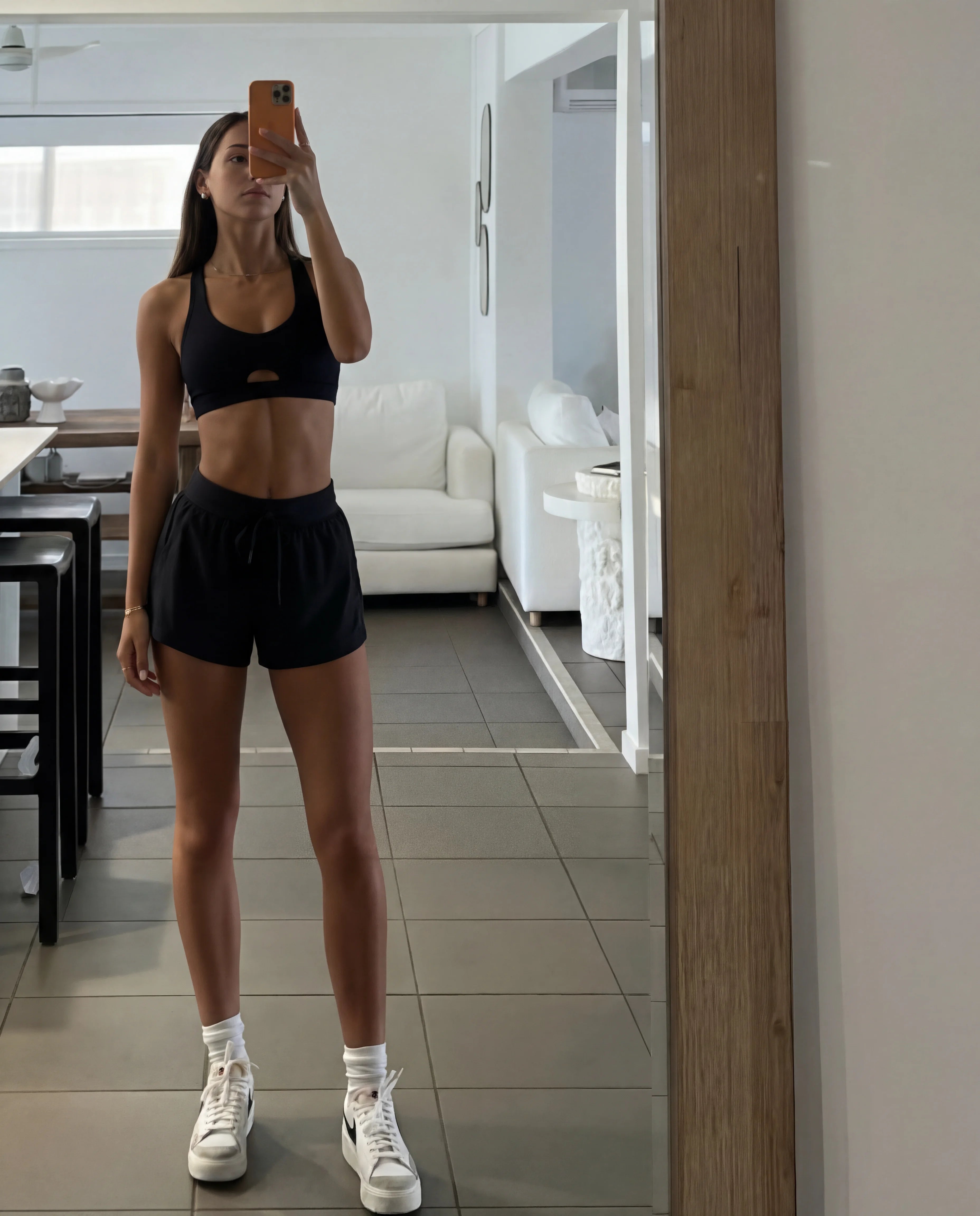 Black workout set heart bra and flyaway shorts home mirror selfie full length